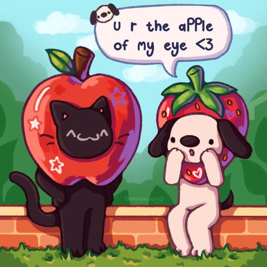 Image shows a black cat with dressed as an apple and a black and white dog dressed as a strawberry exclaiming "u r the apple of my eye"