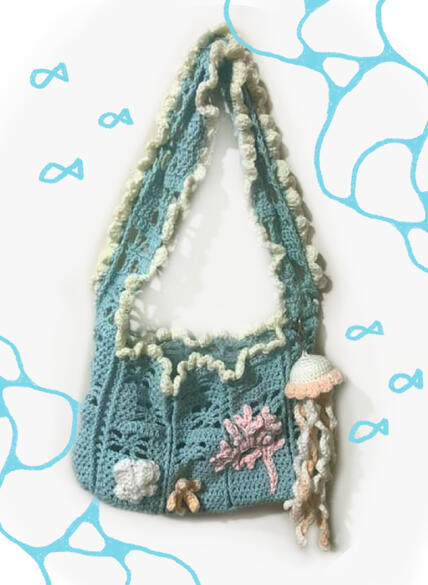 Image shows a blue, ocean themed crochet bag