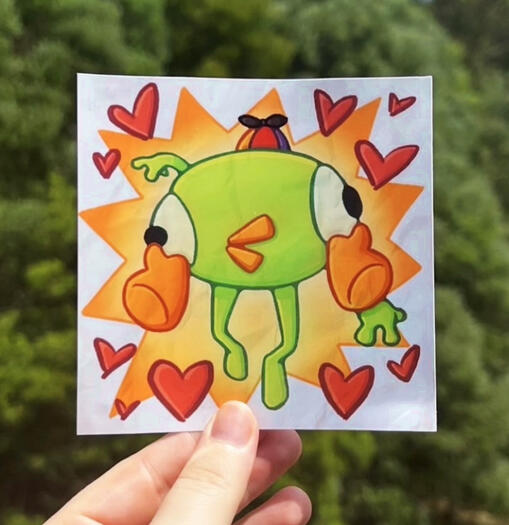Image shows a hand holding a print of Bing Bong from the game Peak